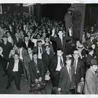 B+W photo of workers boarding train at Lackawanna Terminal, Hoboken, for trip to work at Kaiser shipyards in Oregon, Sept. 26, 1942.