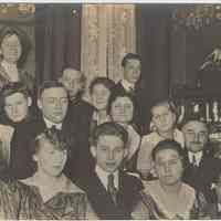 Sepia-tone photo of a group in a home dressed for some occasion, probably Hoboken, no date, ca. 1905-1920.