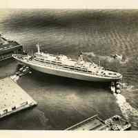          image: S.S. Rotterdam being moved by tugboats to Hoboken pier 5
   