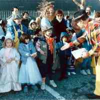 Color photo of the 1985 Hoboken Ragamuffin Parade with Mayor Tom Vezzetti shaking hands with children in costume, Hoboken, October, 1985.