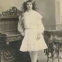 Sepia-tone photo of Madeline Miller posed in the studio of William Manewal, Hoboken, no date, ca. 1900-1910.