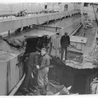 B+W photo of workers inspecting damage on main deck of unknown ship, Hoboken, no date, ca. 1940.