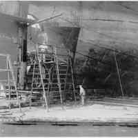 B+W photo of steerage repair to an unknown ship in a dry dock south of the Lackawanna Ferry Terminal, Hoboken, no date, ca. 1922-1930.