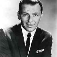 Black-and-white photo of Frank Sinatra in a dark jacket & tie, no place, no date, ca. 1960.