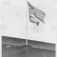 B+W photo of a 48-star American flag with a rectangular pennant below it, Hoboken, no date, ca. 1941-1945.