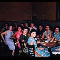 Color slide of a group of women around a table.