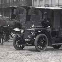         detail lower left: horse-drawn delivery carts; truck (van) with lettering
   