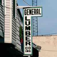 Color photo of a hanging sign for General Lumber, 204 Clinton Street, Hoboken, Jan. 3 & 4, 2002.