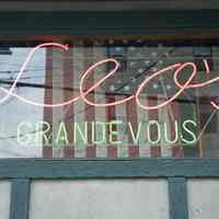 Color photos, 5, of neon window sign for Leo