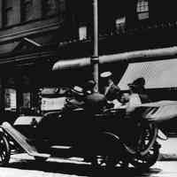 B+W photo of an automobile, jitney autobus, on Hudson St. near Hudson Pl., 1915.