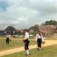 Color photo of three players in period costume on the field at Baseball Day Ceremonies, 1976.