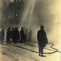 Sepia-tone photo of exterior view of a fire at John Schmalz