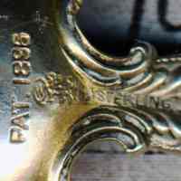          detail neck, back: Patent 1896; maker's mark; sterling mark
   