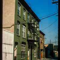 Color slide of eye-level view row house façades with fire escape on Court between 4th & 5th