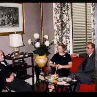 Color slide of Anita Heimbruch and two men in a room.