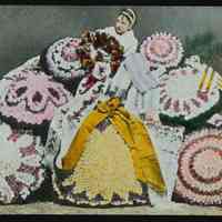 Lantern slide, color, of floral decorated parasols with woman holding a wreath, used for promotional display in Hoboken, no date, ca. 1920.