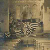 Sepia tone photo of First Baptist Church interior, patriotic decoration, 9th & Bloomfield Sts., Hoboken, n.d., ca. 1908-1912.