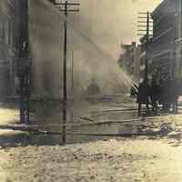 Sepia-tone photo of exterior view of a fire at John Schmalz