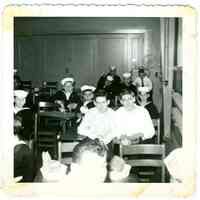 B+W photo of a classroom interior of boys, some in sailors