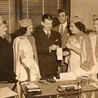 Digital image of sepia-tone photo of Mayor Fred M. DeSapio making contribution to Jewish hospital drive, City Hall, Hoboken, no date, ca. 1947-1951.