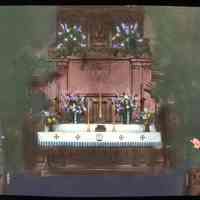 Lantern slide, color, of a church interior with floral decorations, used for promotional display in Hoboken, no date, ca. 1920.