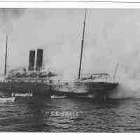 B+W photo of the S.S. Saale with an onboard fire; lifeboats in water, near Hoboken, no date [1900].