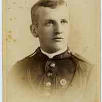 Cabinet photo of man with mustache in military uniform wearing a medal, no date, circa 1885-1890.