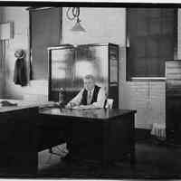 B+W photo of supervisor sitting at desk in drafting room, United Dry Dock Co., Hoboken, 1931