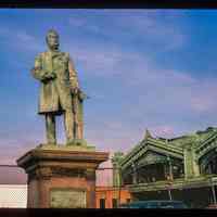 Color slide of eye-level view of the Sam Sloane statue and the Lackawanna Terminal façade