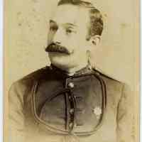 Cabinet photo of man with mustache in military uniform wearing a medal, no date, circa 1885-1890.