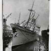 B+W photo of M.S. Oslofjord, Norwegian-America Line, seen listing in drydock, Bethlehem Steel Hoboken Shipyard, ca. Jan. 9 or 10, 1957