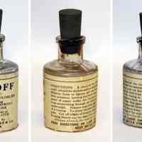          bottle with rubber cork and printed wrap-around label; 3 views
   