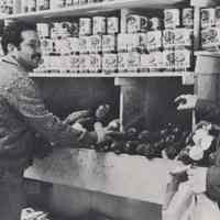Reference image of 2 printed photo images of food store interiors with customers from pg 34 of archives catalog 2002.026.0002, Hoboken, ca. 1975.
