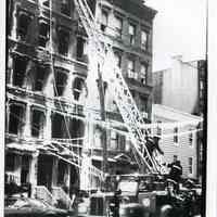 B+W photo of Hoboken firemen outside the burnt-out tenement at 121 Clinton St., Hoboken, Jan. 20, 1979.