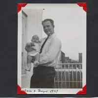          40: man holding young baby on balcony or porch: Aare{?) & Hugo(?} 1929
   