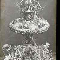 Lantern slide, b+w, of a table floral decoration with lettering, used for promotional display in Hoboken, no date, ca. 1920.