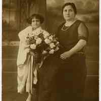 Sepia-tone photo of girl with fur-collared robe posed with her mother, Hoboken, n.d., ca. 1900-1920.
