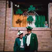 Color photo of woman and man in Irish dress posed outside Shannon Lounge, First St., Hoboken, n.d, ca. 1980-1985.