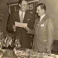 Digital image of sepia-tone photo of Mayor Fred DeSapio with Mel Allen of the N.Y. Yankees at a Lions Club function, Hoboken, no date, ca. 1950-1953.