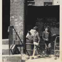 B+W photo of two boys near trash barrel on Clinton Street near First St., Hoboken, no date, ca. 1970-1975.