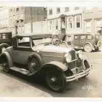 Sepia-tone photo of passenger automobile parked on unidentified street, Hoboken, Aug. 17, 1931.