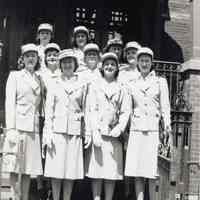 Black-and-white group photo of 10 American Red Cross Volunteers, World War II, outside an unidentified building, Hoboken, no date, ca. 1942-45