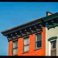 Color slide of close-up view of cornices, brackets, dentils and window heads on two buildings at an unidentified location