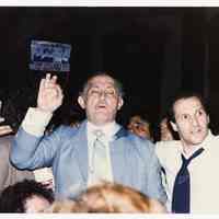 Color photo of mayoral candidate Tom Vezzetti in front of City Hall with supporters on election night, Hoboken, [June 11, 1985].