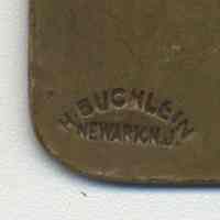          detail reverse tag 3, maker's mark: H. Buchlein, Newark, N.J.
   