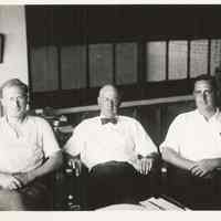 B+W photo of R. Neumann & Co., three men in an office, Hoboken, no date, ca. 1950-60.