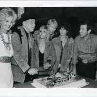 B+W photo of Frank Sinatra with his wife & children cutting a cake with train on it, n.p., n.d., ca. 1976-1981.