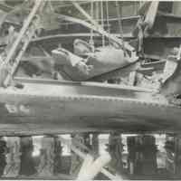 B+W photo of exterior view of hull plate and structural repairs underway on unidentified vessel at the Bethlehem Steel Shipyard, Hoboken Division, no