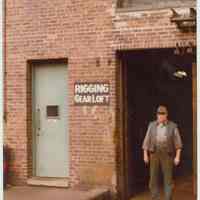          Color photo of Charlie Kosbab standing in the doorway of the Rigging Gear Loft at the Bethlehem Steel Shipyard, Hoboken Division, ca. 1980. picture number 1
   