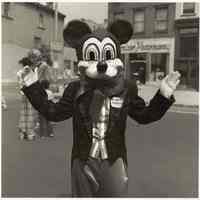 B+W photo of a person wearing a mouse mask & costume on Washington St., Hoboken, no date, [1976].